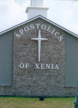 wall letters designed in an arc to compliment the cross on the church wall.